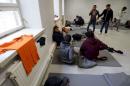 Asylum seekers rest in a refugee center in Lahti
