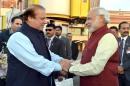 Indian Prime Minister, Narendra Modi (R) shakes hands with Pakistan Prime Minister Nawaz Sharif upon his arrival in Lahore on December 25, 2015