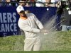 Tiger Woods hits from the bunker behind the 18th green of the South Course at Torrey Pines during the first round of the Farmers Insurance Open golf tournament, Thursday, Jan. 24, 2013, in San Diego. (AP Photo/Lenny Ignelzi)