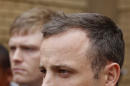 Oscar Pistorius, leaves the high court after the fifth day of his trial in Pretoria, South Africa, Friday, March 7, 2014. Pistorius is charged with murder in the shooting death of girlfriend Reeva Steenkamp in the pre-dawn hours of Valentine's Day 2013. (AP Photo/Schalk van Zuydam)