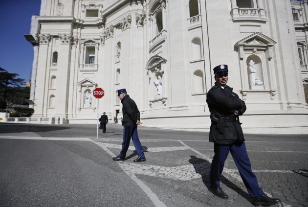 Vatican Police guards patrol in front of the St. Peter's Basilica, at the Vatican, Tuesday, Feb. 19, 2013. Last week, 85-year-old Pope Benedict XVI shocked the world by announcing his resignation. He will step down on Feb. 28, planning to retreat to a life of prayer in a monastery behind the Vatican's ancient walls. (AP Photo/Gregorio Borgia)