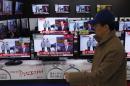 A man walks past televisions showing reports on the execution of Jang Song Thaek, in Seoul