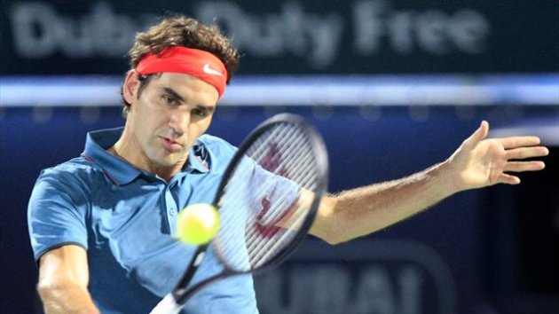 Roger Federer of Switzerland returns the ball to Benjamin Becker of Germany during their men's singles match at the ATP Dubai Tennis Championships (Reuters)