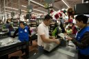 FILE - In this Nov. 18, 2011 file photo, a man pays at the cash register at a Wal-Mart Superstore in Mexico City. Lawmakers are making public emails that show that Wal-Mart Stores Inc.'s CEO found out in 2005 that the retailer was handing out bribes in Mexico. (AP Photo)