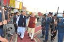 Pakistani Prime Minister Nawaz Sharif walks with his Indian counterpart Narendra Modi after Modi's arrival in Lahore