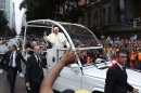 A crowd of faithful cheer as Pope Francis rides in his popemobile in Rio de Janeiro, Brazil, Monday July 22, 2013. The pontiff arrived for a seven-day visit in Brazil, the world's most populous Roman Catholic nation. During his visit, Francis will meet with legions of young Roman Catholics converging on Rio for the church's World Youth Day festival. (AP Photo/Victor R. Caivano)