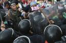 Anti-government protesters confront with riot police during a rally in Bangkok, Thailand, Monday, Nov. 25, 2013. Bangkok braced for major disruptions Monday as a massive anti-government march fanned out to 13 locations in a growing bid to topple the government of Prime Minister Yingluck Shinawatra. (AP Photo/Wason Wanichakorn)