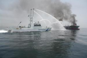 A Coastguard boat (L) fights a fire onboard the 998-tonne&nbsp;&hellip;