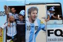 In this Saturday, June 14, 2014 photo, Argentine fans arrive in a bus decorated with a painting of soccer star Lionel Messi at the Copacabana beach in Rio de Janeiro, Brazil. Waving flags and banners, more than a thousand Argentine fans, many dressed in their team's traditional blue and white, crowded the Copacabana beachfront ahead of Argentina's World Cup match against Bosnia-Herzegovina Sunday in Rio's iconic Maracana stadium. (AP Photo/Leo Correa)
