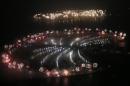Fireworks explode over Palm Jumeirah in Dubai on January 1, 2014 to celebrate the new year