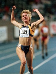 FILE - In this Feb. 27, 1999, file photo, Suzy Hamilton reacts after winning the women's 1,500 meter run with a time of 4:13.96 at the USA Championships athletics meet in Atlanta. he three-time Olympian has admitted leading a double life as an escort. She apologized Thursday, Dec. 20, 2012, after a report by The Smoking Gun website said she had been working as a prostitute in Las Vegas. (AP Photo/John Bazemore, File)