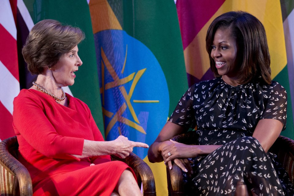 U.S. first lady Michelle Obama, right, and former U.S. first lady Laura Bush talk each other as they participate in the African First Ladies Summit: “Investing in Women: Strengthening Africa,” hosted by the George W. Bush Institute, Tuesday, July 2, 2013, in Dar es Salaam, Tanzania. (AP Photo/Carolyn Kaster)
