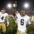 Notre Dame running back Theo Riddick, right, and wide receiver Luke Massa, left, celebrate after Notre Dame defeated Southern California 22-13 in an NCAA college football game, Saturday, Nov. 24, 2012, in Los Angeles. (AP Photo/Danny Moloshok)