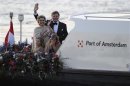 Dutch King Willem-Alexander waves to the crowd next to his wife Queen Maxima and their daughters Crown Princess Catharina-Amalia and Princess Alexia during a boat parade in Amsterdam