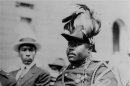FILE - In this Aug. 1922 file photo, Marcus Garvey is shown in a military uniform as the "Provisional President of Africa" during a parade on the opening day of the annual Convention of the Negro Peoples of the World at Lenox Avenue in Harlem, New York City. A century ago, Garvey helped spark movements from African nationalist independence to American civil rights to self-sufficiency in black commerce. Jamaican students in every grade from kindergarten through high school have began studying the teachings of the 1920-era black nationalist leader in a new mandatory civics program in schools across this predominantly black country of 2.8 million people. (AP Photo/File)