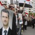 Pro-Syrian regime protesters, hold portraits of Syrian President Bashar Assad and shout slogans against the Arab League, as they gather outside the Syrian foreign ministry where Syrian Foreign Minister Walid al-Moallem helds a press conference, in Damascus, Syria, on Monday Nov. 14, 2011. Syria's foreign minister accused Arab states on Monday of conspiring against Damascus after the Arab League voted to suspend Syria's membership over the government's deadly crackdown on an eight month-old uprising. (AP Photo/Muzaffar Salman)