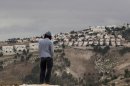 A Jewish settler looks at the West bank settlement of Maaleh Adumim, from the E-1 area on the eastern outskirts of Jerusalem, Wednesday, Dec. 5, 2012. An Israeli-Palestinian showdown over plans for new Jewish settlements around Jerusalem escalated on Wednesday: Israel pushed the most contentious of the projects further along in the planning pipeline, while the Palestinian president said he would seek U.N. Security Council help to block the construction. (AP Photo/Sebastian Scheiner)