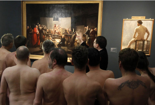 RETRANSMISSION  OF XRZ102 In this Monday, Feb. 18, 2013 photo, Naked Museum visitors look at pictures of the show 