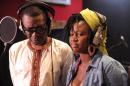 Senegalese music icon Youssou N'Dour (L) stands with Central African singer Idylle Mamba (R) on January 26, 2014 in Dakar