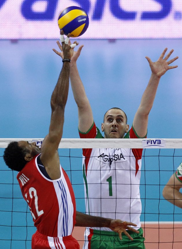 Bell of Cuba spikes the ball against Bratoev of Bulgaria during their FIVB World League third place men's volleyball match at Arena Armeec hall in Sofia