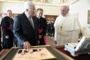 This handout picture released on October 17, 2013 by the Vatican press office shows Pope Francis (R) speaking with Palestinian president Mahmud Abbas during a private audience