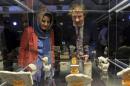 An invited guest from British Museum, right, and an official from Iraq Museum look at antiquities on display at a newly opened museum in the southern city of Basra, Iraq, Tuesday, Sept. 27, 2016. Iraq inaugurated the new antiquities museum in Basra on Tuesday, with pottery, statues, coins and other artifacts dating back more than 2,000 years. Only one hall was opened due to a shortage of funds. The museum is housed in one of Saddam Hussein's former palaces, which had briefly served as a mess hall for British troops after the 2003 U.S.-led invasion that overthrew him. It will showcase artifacts dating back to 400 B.C. that tell the history of the oil-rich city on the Persian Gulf. (AP Photo/Nabil al-Jurani)