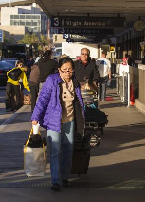 Departing passengers with their luggage arrive on Saturday, …