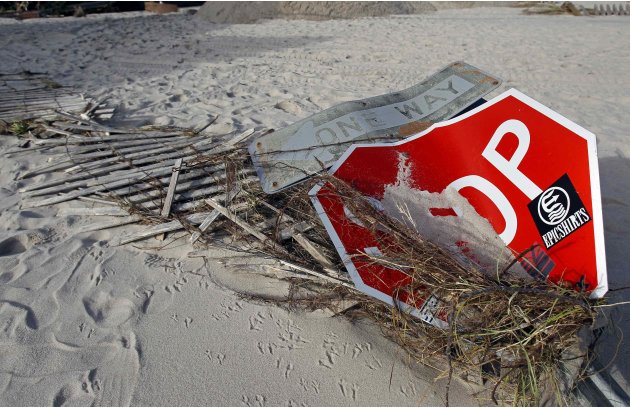 Street signs are seen after they were knocked down next to damaged fencing caused by Hurricane Sandy in Bay Head
