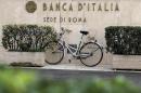 A bicycle is parked in front of a Bank of Italy sign in Rome