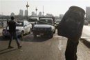 Opponents of deposed President Mursi control traffic, as they prepare after reports of a possible pro-Mursi rally, in Cairo