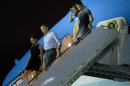 Sasha Obama (L), US President Barack Obama (2L), Malia Obama (2R) and US First Lady Michelle Obama arrive at Hickam Air Force Base in Honolulu, Hawaii on December 19, 2015