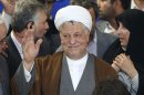 In this picture taken on Saturday, May 11, 2013, former Iranian President Akbar Hashemi Rafsanjani waves to media as he registers his candidacy for the upcoming presidential election, while his daughter Fatemeh, right, looks on, at the election headquarters of the interior ministry in Tehran, Iran. A hardline news website says Iran's election overseers have rejected a pair of powerful and divisive figures from running in next month's presidential election. Tasnimnews.com say Akbar Hashemi Rafsanjani, a former president who still wields enormous influence, and Esfandiar Rahim Mashaei, a close confident of President Mahmoud Ahmadinejad, have been barred by the Guardian Council. (AP Photo/Ebrahim Noroozi)
