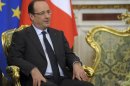 France's President Hollande listens during talks with Russia's President Putin in Moscow's Kremlin