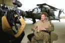 Britain's Prince Harry gives an interview to media in an Apache helicopter repair hanger at Camp Bastion, southern Afghanistan