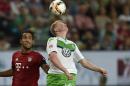 Wolfburg's Kevin De Bruyne from Belgium, right, and Bayern's Medhi Benatia from Morocco challenge for the ball during the German Supercup final soccer match between VfL Wolfsburg and Bayern Munich in Wolfsburg, Germany, Saturday, Aug. 1, 2015. (AP Photo/Martin Meissner)