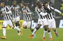 Juventus' Andrea Pirlo, right, and Angelo Ogbonna, second right, celebrate with teammates during a Serie A soccer match against Torino at the Juventus stadium in Turin, Italy, Sunday, Nov. 30, 2014. Juventus midfielder Andrea Pirlo scored deep into stoppage time as 10-man Juventus snatched a 2-1 win over Torino in a derby match on Sunday to move provisionally six points clear in Serie A. (AP Photo/Massimo Pinca)