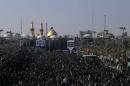 Shiite Muslims gather outside the Imam Hussein shrine on December 11, 2014, in the central Iraqi city of Karbala in preparation for the the Arbaeen religious festival