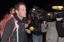 Journalists surround convicted rogue trader Jerome Kerviel as he arrives on the Franco-Italian border in Menton
