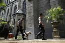 Member of Indonesian Police bomb squad search for suspicious materials as they anticipate terror attacks prior to the Christmas Eve mass at the Cathedral in Jakarta, Indonesia, Thursday, Dec. 24, 2015. The Indonesian government has deployed around 150,000 security personnel across the country to safeguard churches, airports and other public places, as officials believe a credible threat of terrorist attacks remains in the year-end holiday season in this predominantly Muslim nation, especially against minority Christians. (AP Photo/Achmad Ibrahim)