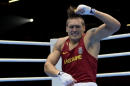 FILe - In this Aug. 11, 2012 file photo, Oleksandr Usyk of Ukraine, dances after winning against Clemente Russo of Italy, in their heavyweight 91-kg gold medal boxing match at the 2012 Summer Olympics in London. Usyk was so excited about winning the heavyweight gold medal that he broke into a traditional Ukrainian dance in the ring. But the Ukraine he pointed to so proudly on the front of his boxing uniform is a different country from the one two years ago. (AP Photo/Ivan Sekretarev, File)
