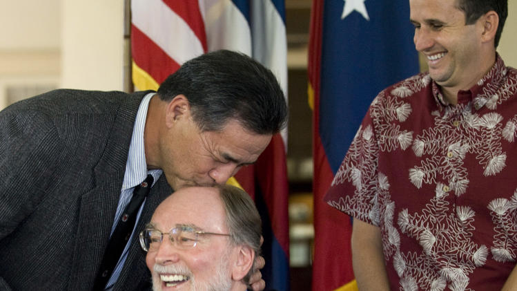 Hawaii Senator Clayton Hee playfully gives Hawaii Gov. Neil Abercrombie a kiss on the head before he signs the Hawaii Civil Unions bill into law at a ceremony held in Washington Place Wednesday, Feb. 23, 2011 in Honolulu. Hawaii Lt. Gov. Brian Schatz , right, looks on. The new Civil Unions law makes Hawaii the seventh state to give essentially the same rights of marriage to same-sex couples through civil unions or similar laws. (AP Photo/Eugene Tanner)