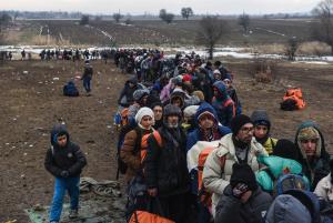 Migrants and refugees wait in line for a security check&nbsp;&hellip;