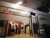 Customers use ATM machines at an ICICI Bank branch in Mumbai