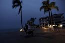 A man walks with his dog along the city's historic boardwalk as Hurricane Patricia approaches the Pacific beach resort of Puerto Vallarta, Mexico