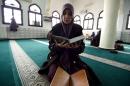 One of the hundreds of female religious guides knows as Mourshidates appointed by the religious affairs ministry to spread the good word of Islam and a message of tolerance, reads the Koran, at the Ennidal mosque in Algiers, on February 22, 2015