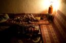 Palestinian children sleep on metresses laid out on the floor near a gas lamp during power cuts in al-Shati refugee camp in Gaza City on November 5, 2013