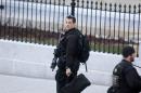 U.S. Secret Service agents walk at the White House in Washington