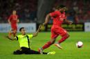 Liverpool's English midfielder Jordon Ibe (R) dribbles the ball past Malaysia XI's Nasir Basharudin during their friendly football match in Kuala Lumpur on July 24, 2015