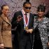 Boxing great Muhammad Ali waves after being awarded the Liberty Medal, as his wife Lonnie and sister-in-law Marilyn Williams look on, at the National Constitution Center in Philadelphia