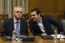 Greek Prime Minister Tsipras talks to Deputy Prime Minister Dragasakis during the first meeting of new cabinet post elections in the parliament building in Athens